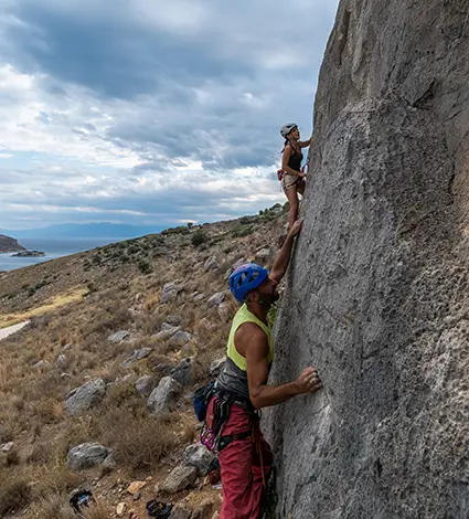 People rock climbing in Karathona beach Nafplio