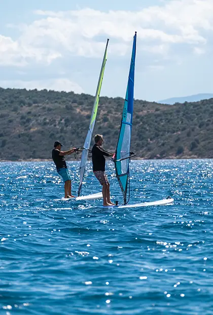 Man on SUP board with friends following him 